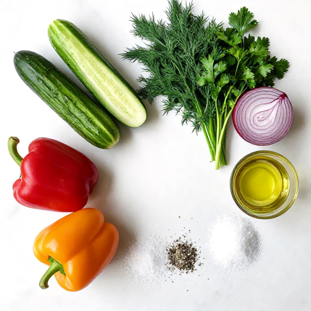 Cucumber, sweet pepper, red onion, and other ingredients on a white marble surface