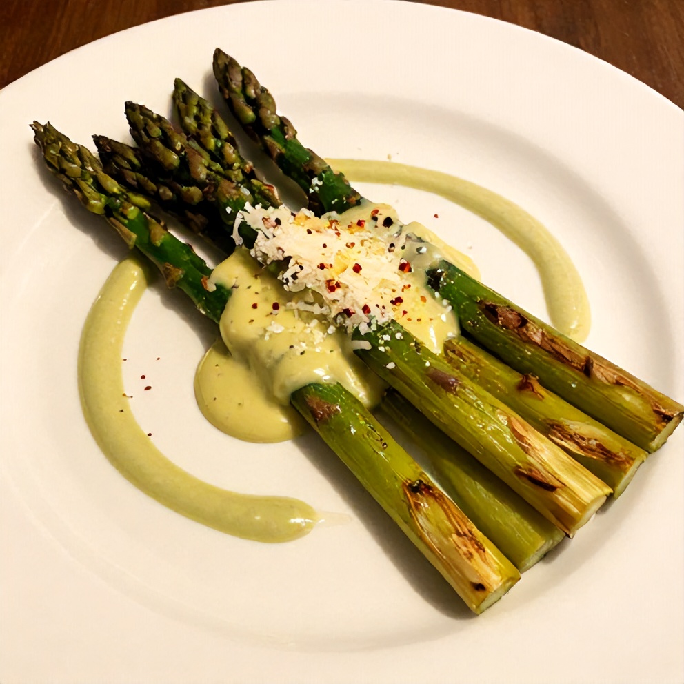Plated grilled asparagus with tahini lemon sauce