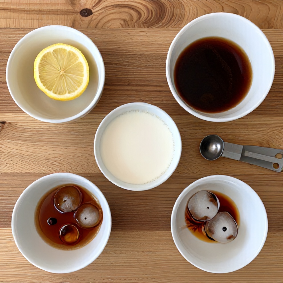 Ingredients for Iced Spanish Latte laid out on a wooden surface